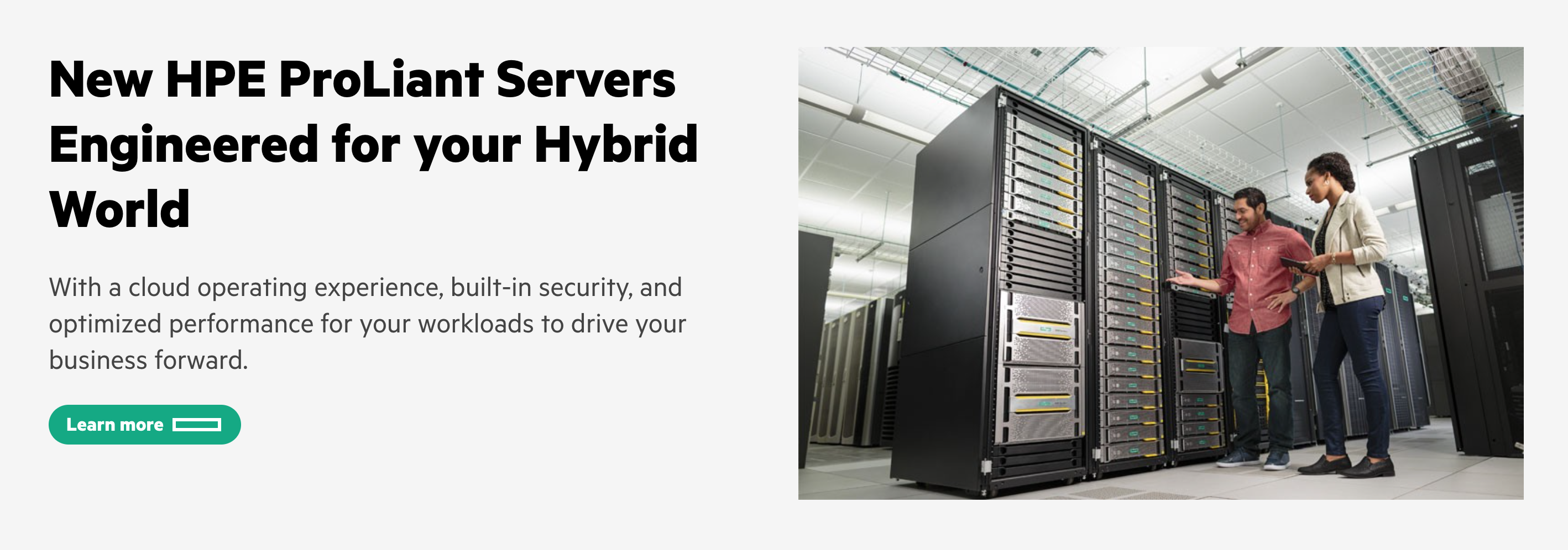 Hero section with a heading, paragraph, button, and image of two IT professionals inspecting a server rack.