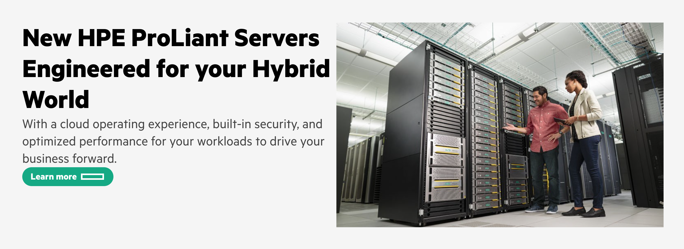 Hero section with a heading, paragraph, button, and image of two IT professionals inspecting a server rack.